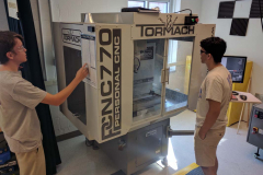 Students learning how to use the Tormach CNC Mill